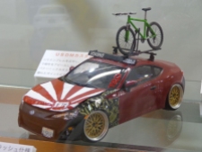 This is a model kit that I assume was a Toyota GT86 since it was right hand drive. However, it has been given a US style treatment with a stickerbombed fender, Yakima bike rack, and Scion FR-S badging.