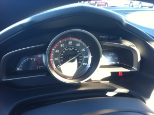 Simple instrument cluster that would be improved with an analog, center-mounted tachometer.